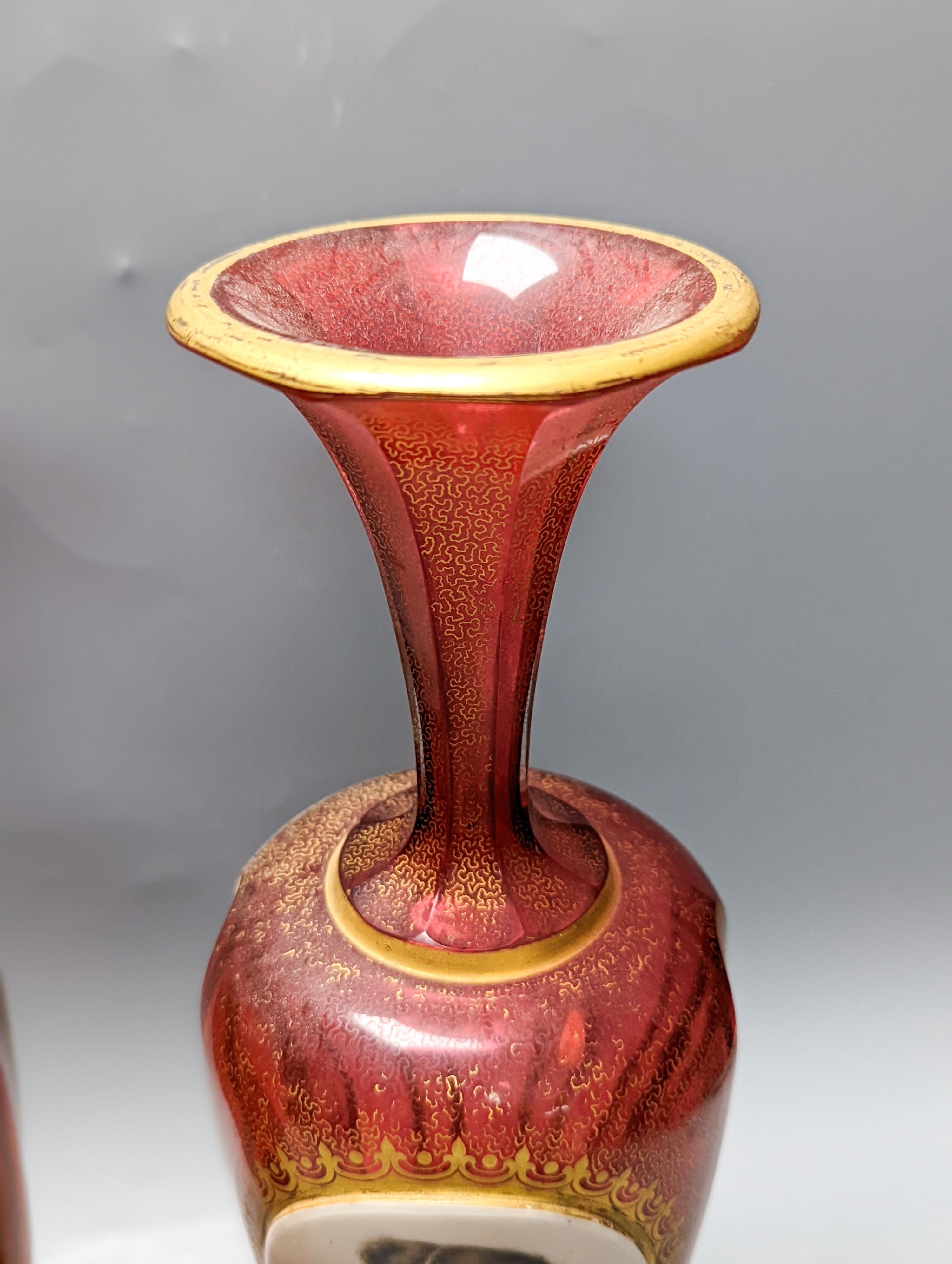 A pair of Bohemian enamelled and overlaid cranberry glass vases, 19th century 35cm